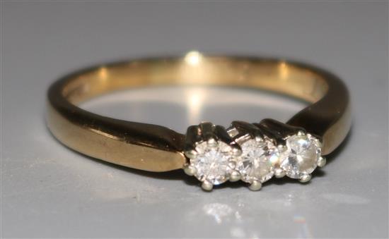 A 9ct gold and three stone diamond ring, size N.